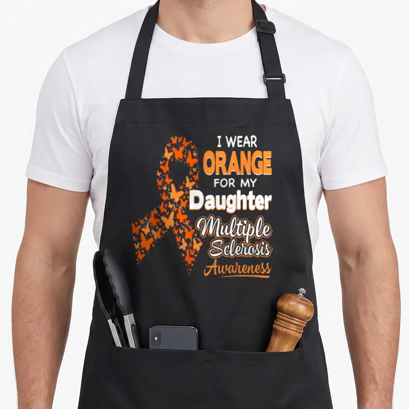 Daughter multiple sclerosis awareness apron - Orange butterfly awareness ribbon with stacked text reading I wear orange — shown on a black cotton canvas apron against a white background