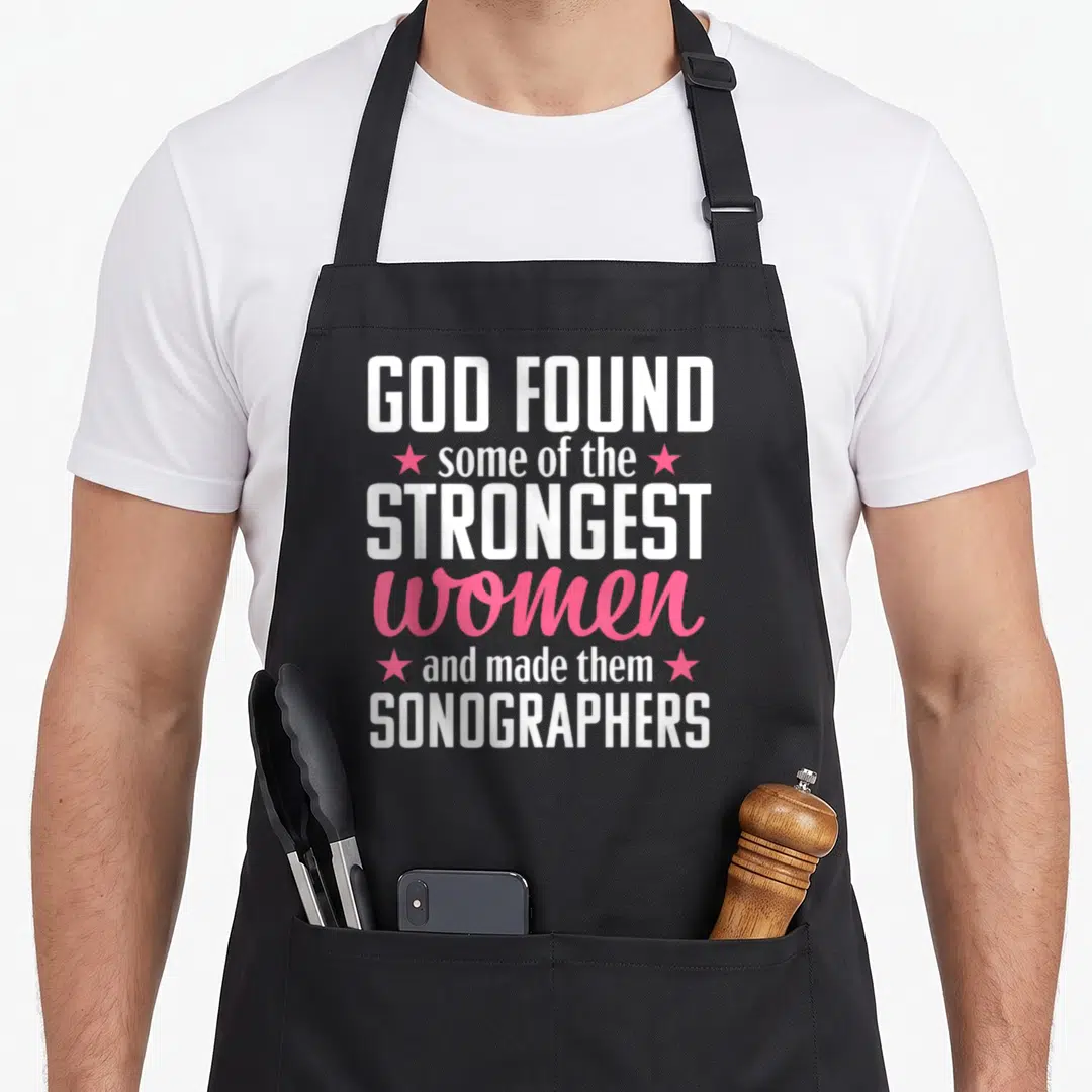 Ultrasound sonographer humor apron - White and pink stacked text reading God found strongest women sonographers — shown on a black cotton canvas apron against a white background