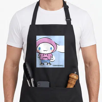 Collection streetwear apron - Cinnamoroll in purple hoodie on light blue with GINNAMOROLL text at bottom right — shown on a black cotton canvas apron against a white background
