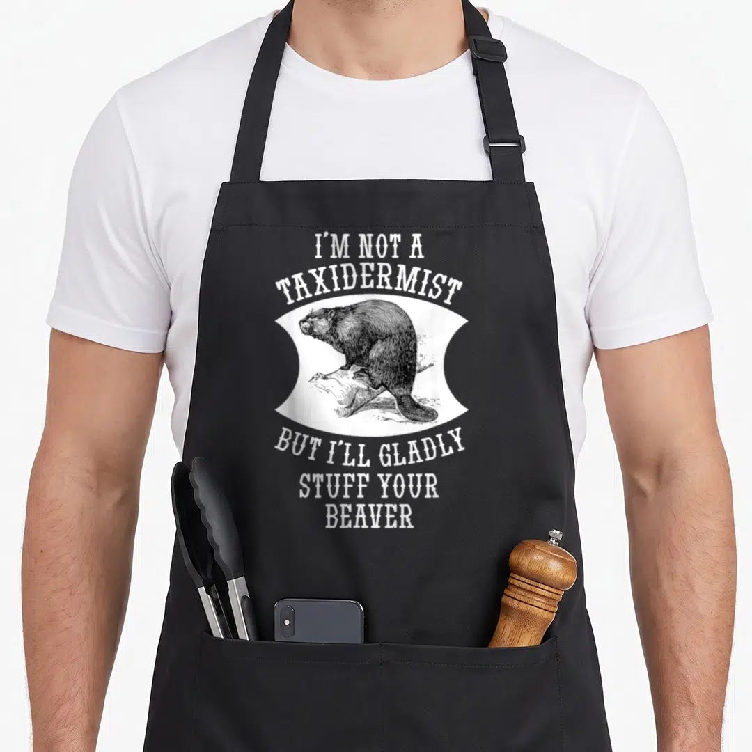 But beaver apron - Retro black beaver on log with white taxidermist pun text on white background shape — shown on a black cotton canvas apron against a white background