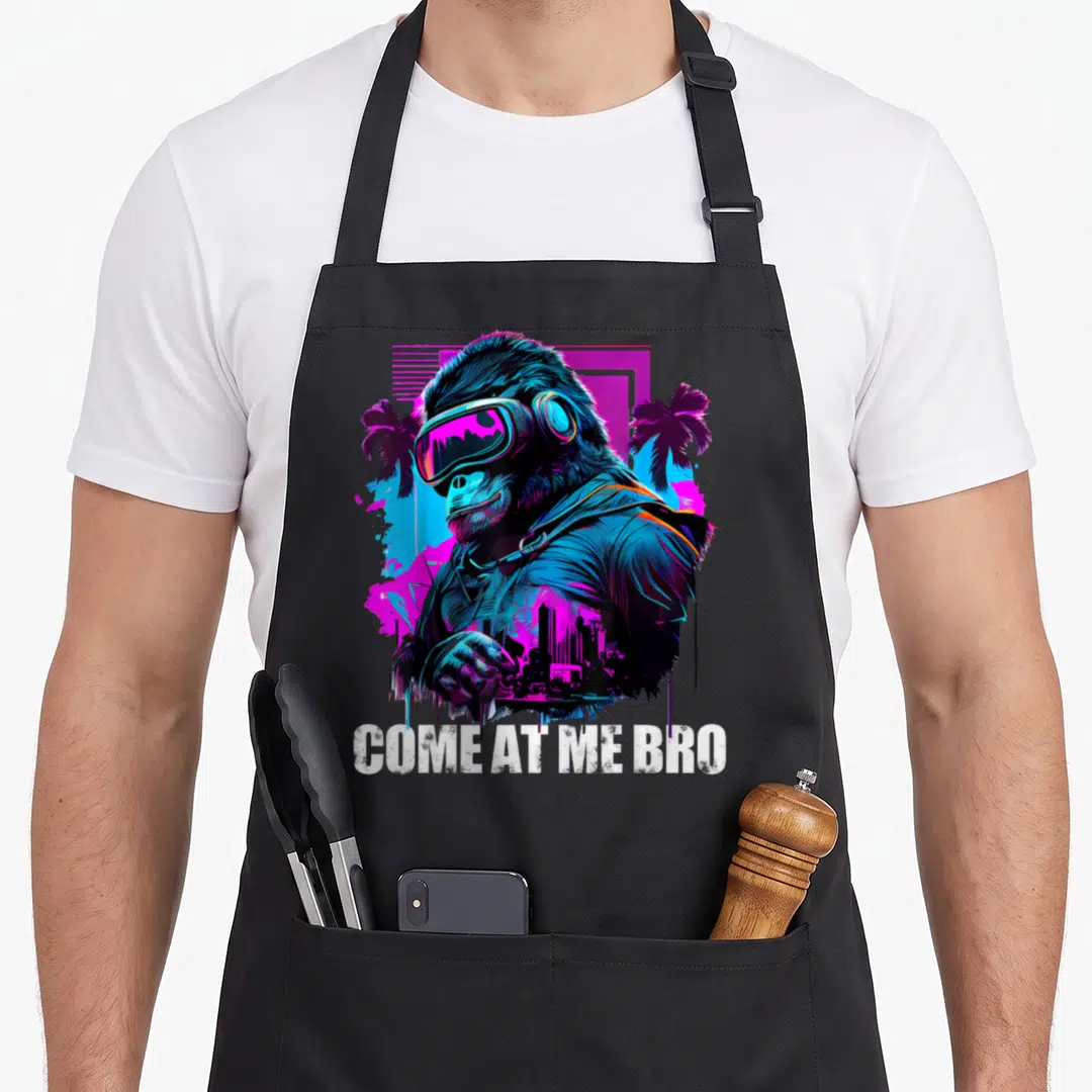 Come virtual reality apron - Neon gorilla wearing VR headset with palm trees and city skyline below white text — shown on a black cotton canvas apron against a white background