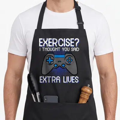 Exercise gaming apron - Grey game controller with blue halftone dots and white text reading exercise I thought you said — shown on a black cotton canvas apron against a white background