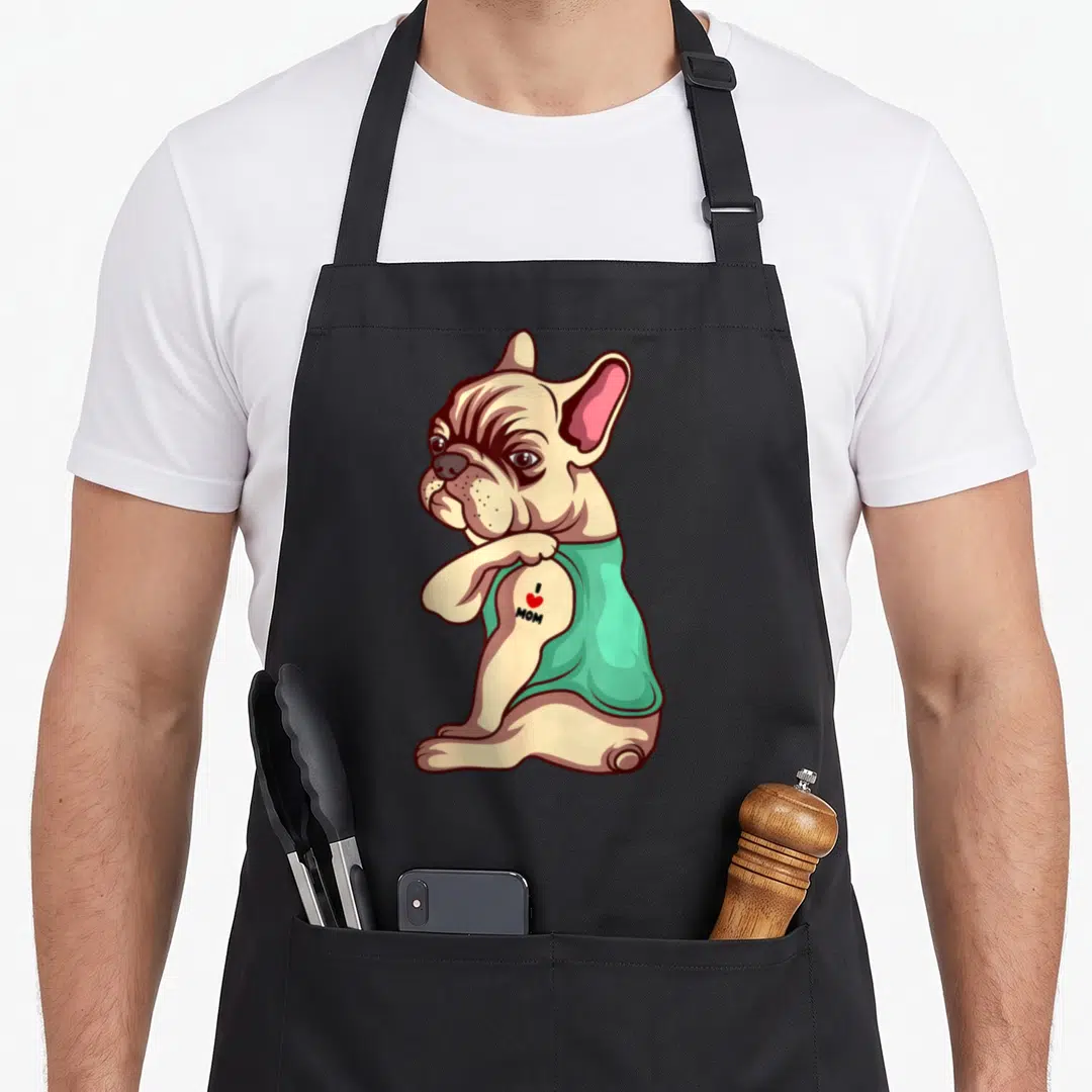 Tattoo french bulldog apron - Cartoon tan french bulldog in teal shirt with I MOM tattoo and red heart on arm — shown on a black cotton canvas apron against a white background