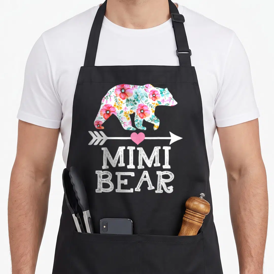 Mimi cute bear apron - Floral bear silhouette with arrow, heart, and MIMI BEAR text — shown on a black cotton canvas apron against a white background