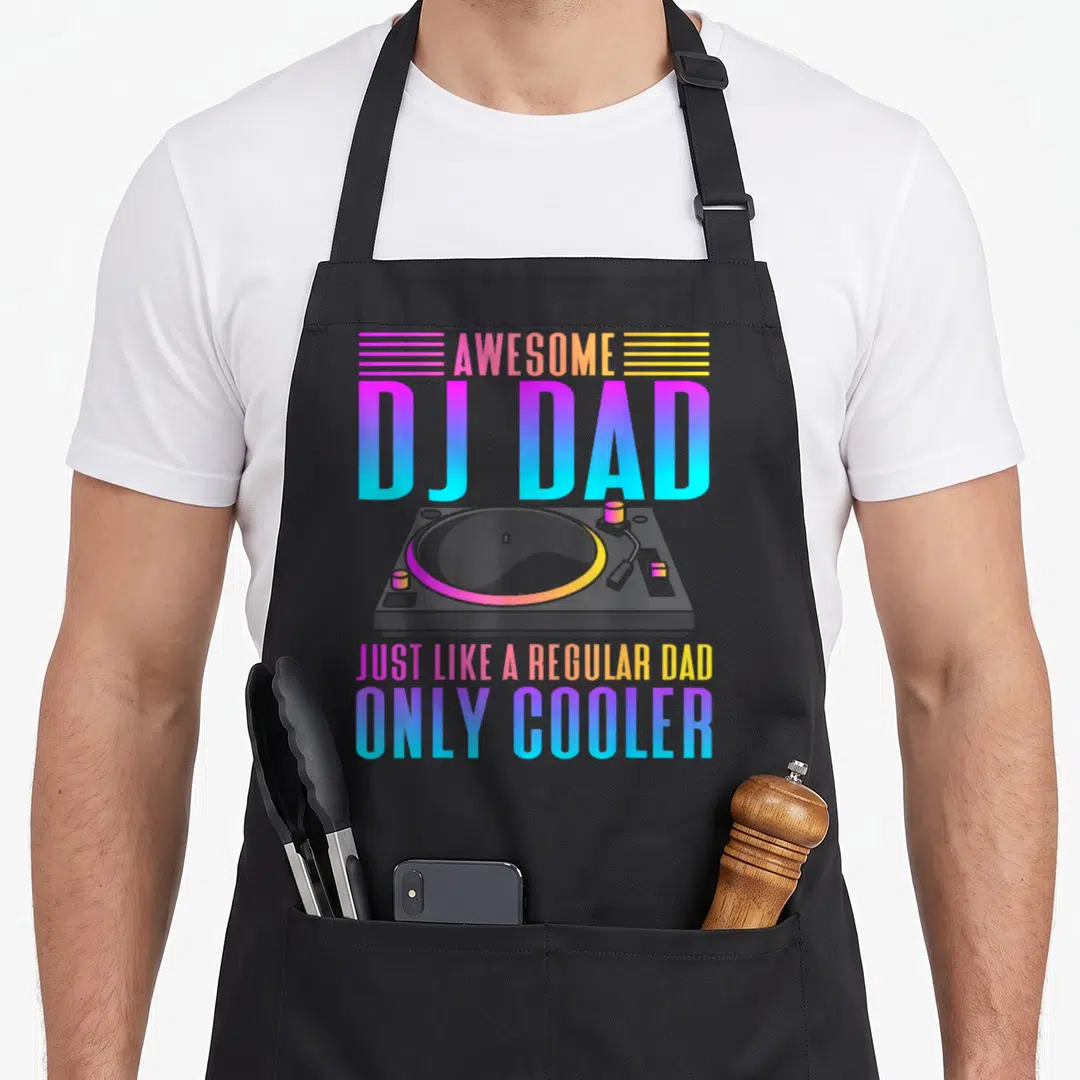 Funny music dad apron - DJ turntable graphic with AWESOME DJ DAD text in blue purple orange yellow gradient — shown on a black cotton canvas apron against a white background