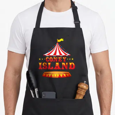 Coney new york apron - Red and white circus tent with Coney Island text and ring base — shown on a black cotton canvas apron against a white background