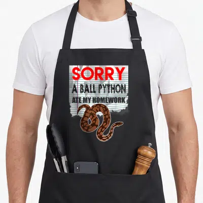 Ball pet apron - Torn lined paper with red text and coiled brown cartoon ball python — shown on a black cotton canvas apron against a white background