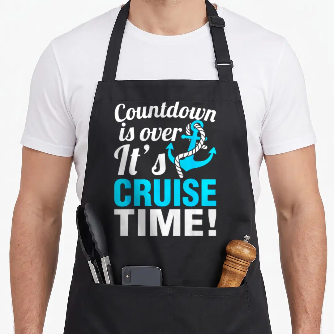 Cruise cruising countdown apron - Stacked white and blue text reading Countdown is over It's CRUISE TIME! beside a blue — shown on a black cotton canvas apron against a white background
