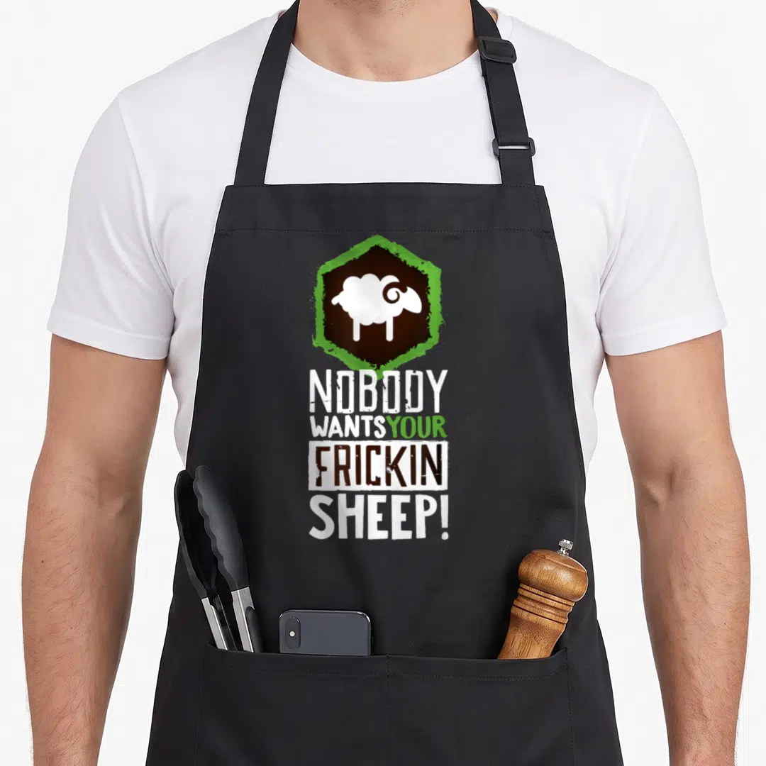 Nobody geek aprons - White sheep silhouette in brown and green hexagon with stacked text Nobody Wants Your Frickin Sheep — shown on a black cotton canvas apron against a white background