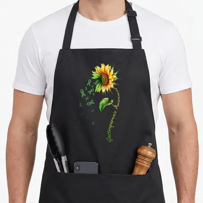 Gastroparesis sunflower apron - Watercolor sunflower with green ribbons and curved awareness text on black fabric — shown on a black cotton canvas apron against a white background