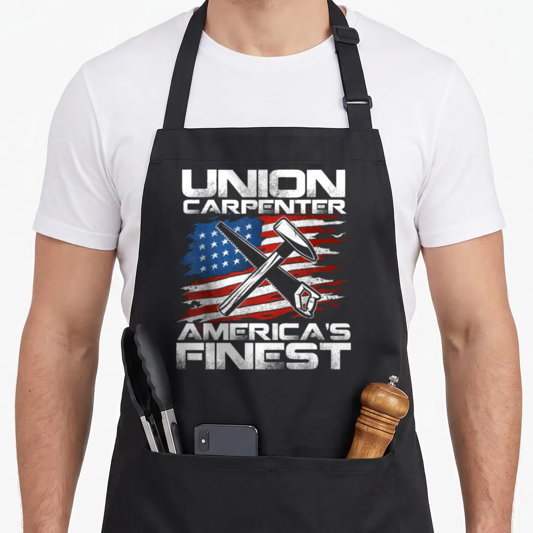 Carpenter union aprons - Distressed US flag with crossed hammer and saw, white text reading Union Carpenter America's — shown on a black cotton canvas apron against a white background