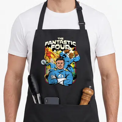 Fantastic step apron - Retro cartoon print of four superheroes in blue suits with stacked white title text — shown on a black cotton canvas apron against a white background