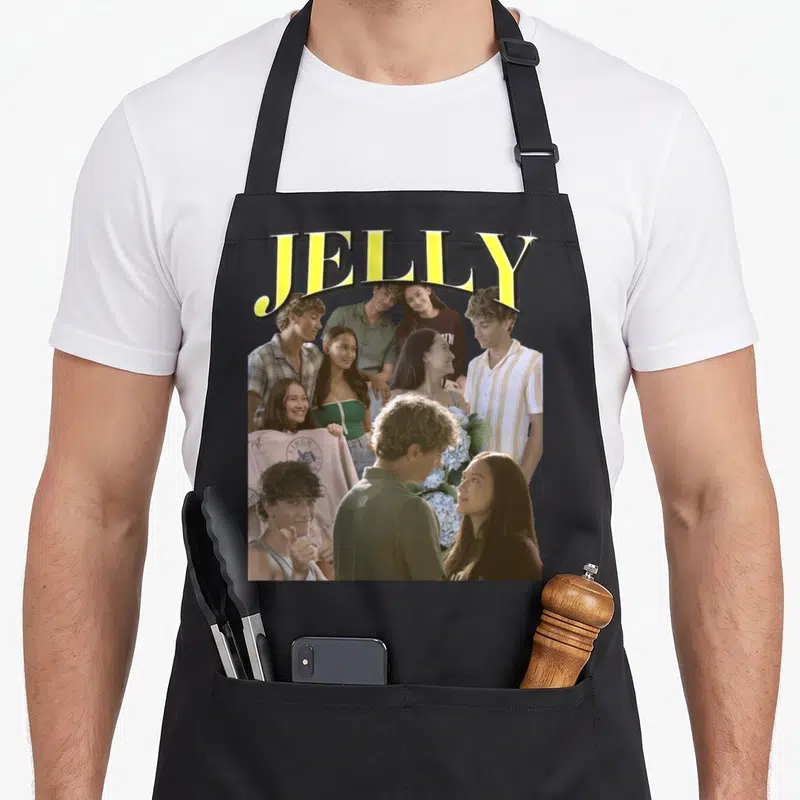 Jelly pretty apron - JELLY in yellow over collage of young people and blue flower bouquet — shown on a black cotton canvas apron against a white background