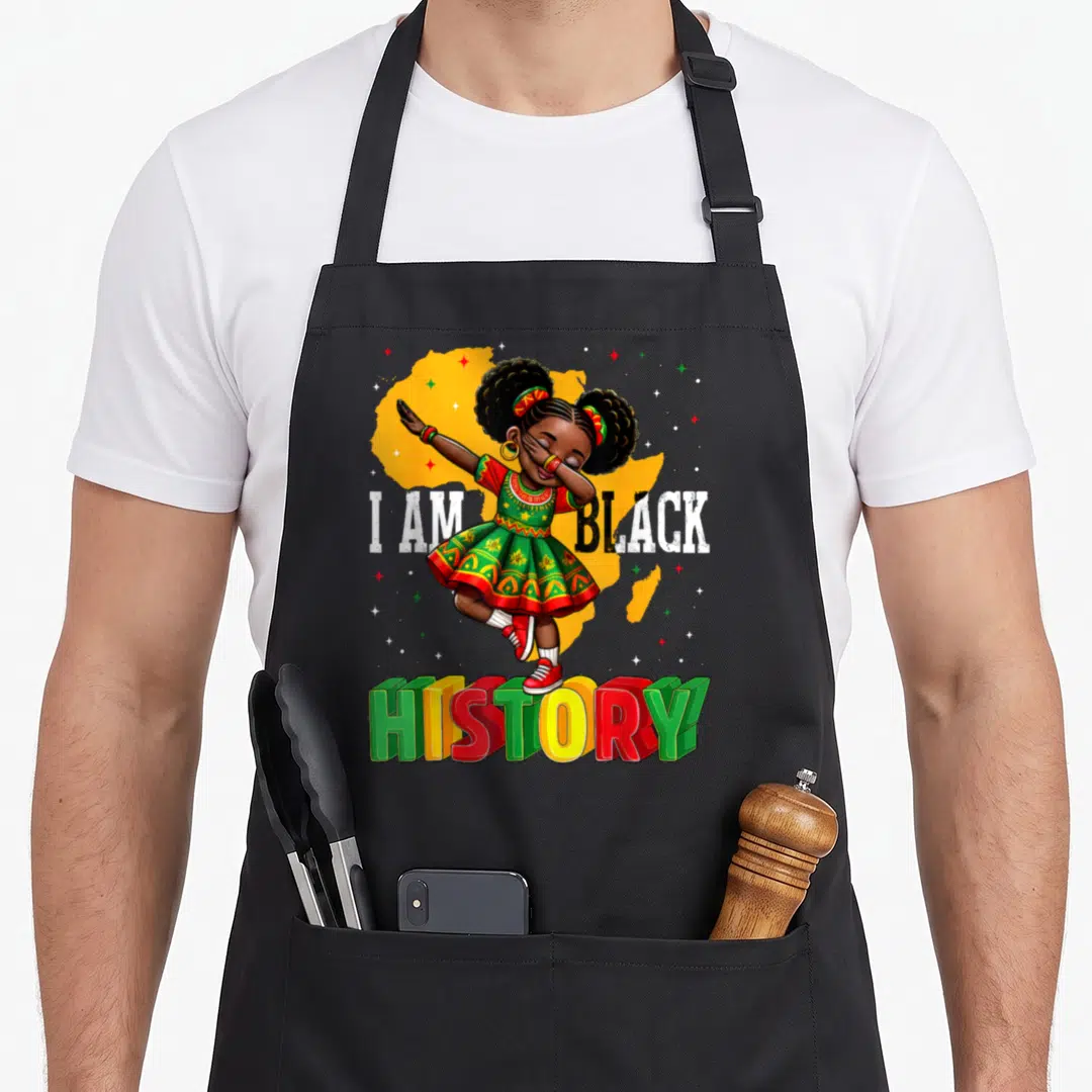 Funny history african american aprons - Cartoon girl dabbing in front of yellow Africa map with I AM BLACK HISTORY text — shown on a black cotton canvas apron against a white background