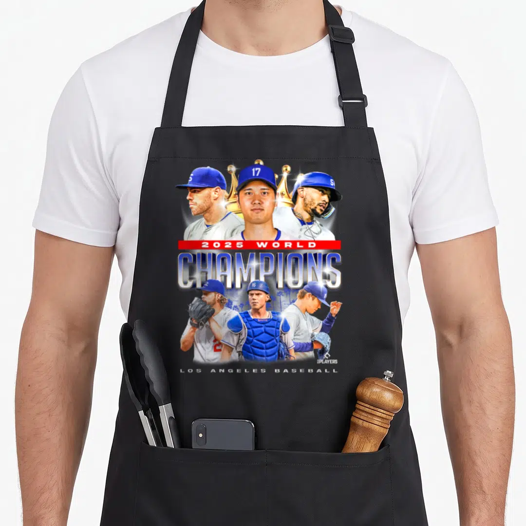 Los novelty apron - Six baseball players surrounding a gold crown with 2025 World Champions text and palm trees — shown on a black cotton canvas apron against a white background