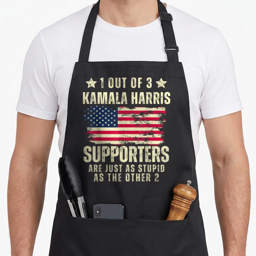 Anti american flag apron - Distressed USA flag with sarcastic text about Kamala Harris supporters flanked by two stars — shown on a black cotton canvas apron against a white background