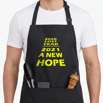 Lost hope apron - Stacked yellow text reading 2020 Lost Year 2021 A New Hope — shown on a black cotton canvas apron against a white background