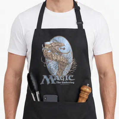 Urza magic apron - Mechanical creature head in distressed blue oval with MAGIC The Gathering text below — shown on a black cotton canvas apron against a white background