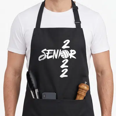 Graduating senior class player apron - White SENIOR text with volleyball graphic and stacked 2022 numbers — shown on a black cotton canvas apron against a white background