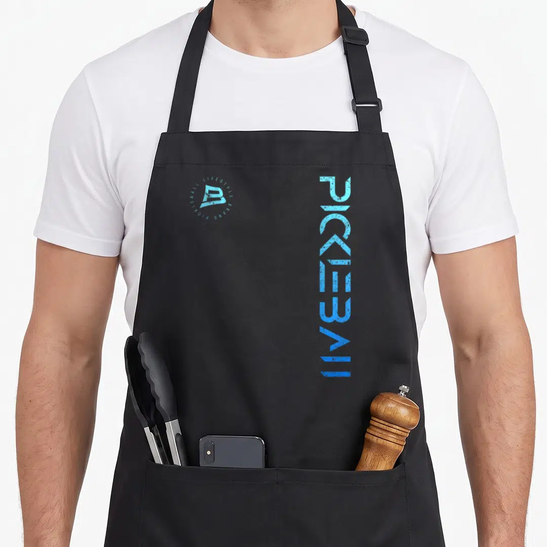 Distressed pickleball apron - Vertical PICKLEBALL text in blue gradient next to a circular logo reading Lifestyle Brand — shown on a black cotton canvas apron against a white background