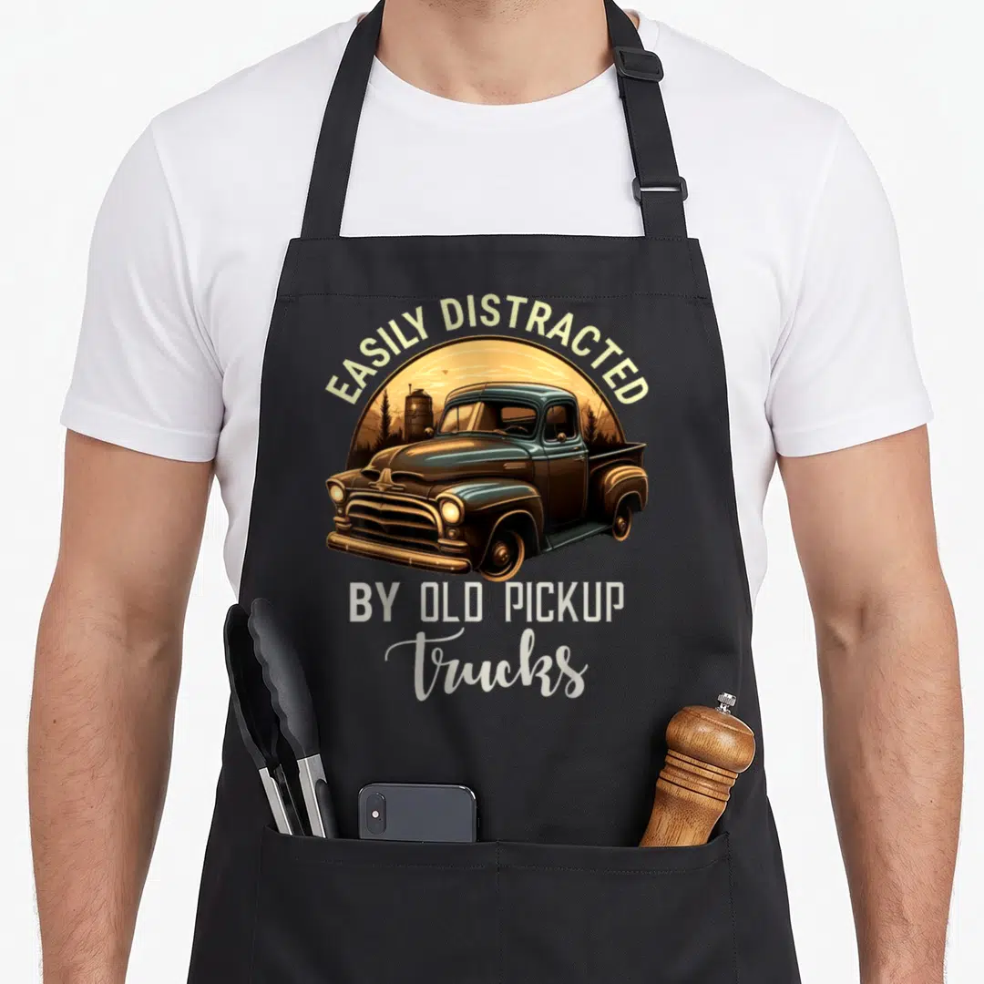 Easily distracted pickup car truck apron - Retro blue pickup truck illustration with arched text EASILY DISTRACTED — shown on a black cotton canvas apron against a white background