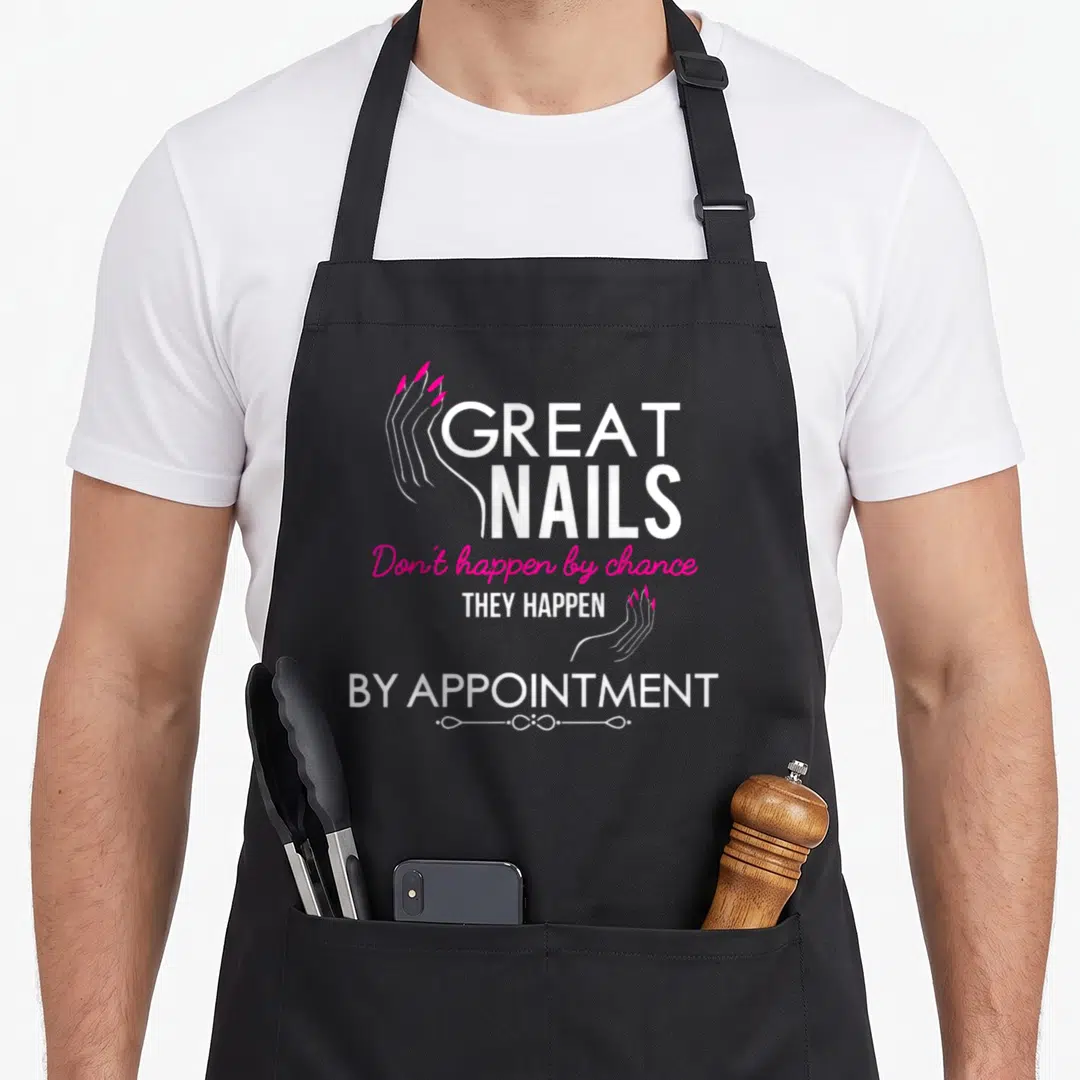 Nail manicurist apron - White and magenta text reading Great Nails Happen By Appointment with line art hands — shown on a black cotton canvas apron against a white background