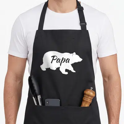 Papabear father day apron - White bear silhouette with grey Papa text inside — shown on a black cotton canvas apron against a white background