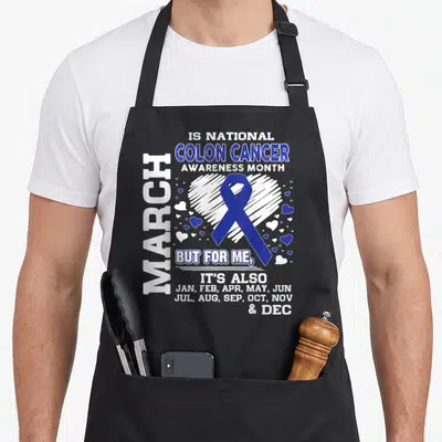 March colon cancer awareness apron - Blue ribbon over white heart with text listing all months for colon cancer support — shown on a black cotton canvas apron against a white background