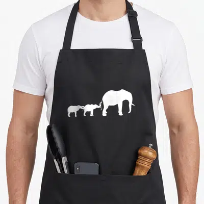 Africa mother's apron - Three white elephant silhouettes in a row facing right, smallest left touching largest tail — shown on a black cotton canvas apron against a white background