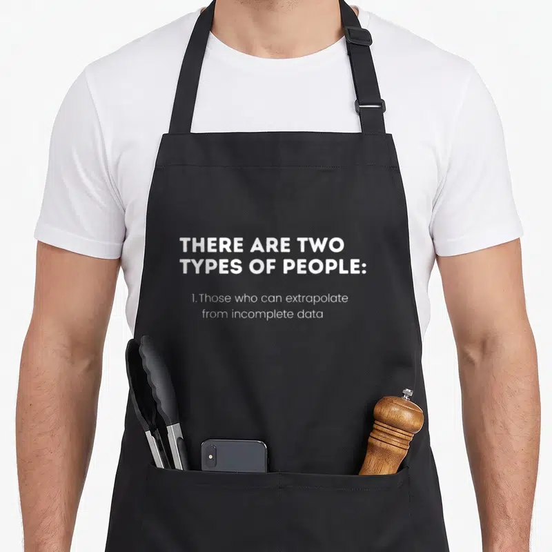 Intelligent smart apron - White text on grey background reading THERE ARE TWO TYPES OF PEOPLE and extrapolate — shown on a black cotton canvas apron against a white background