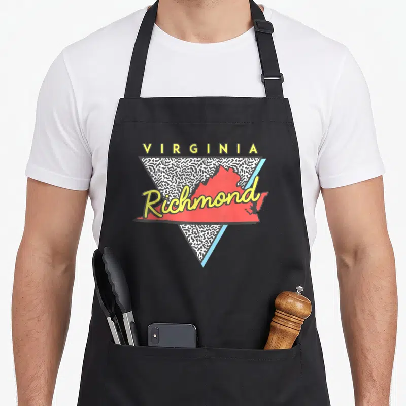 Triangle richmond apron - Red Virginia map with yellow Richmond script inside black scribble triangle — shown on a black cotton canvas apron against a white background