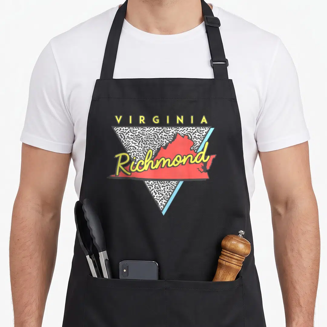 Triangle richmond apron - Red Virginia map with yellow Richmond script inside black scribble triangle — shown on a black cotton canvas apron against a white background
