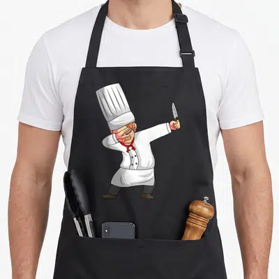 Dabbing chiefs apron - Cartoon chef in white hat dabbing while holding a knife aloft — shown on a black cotton canvas apron against a white background
