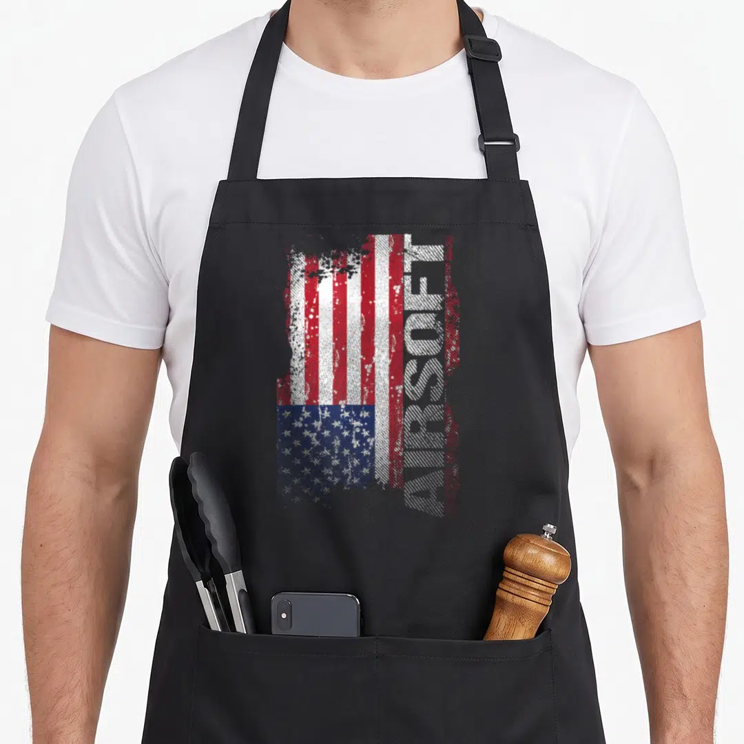 Flag shooting apron - Distressed USA flag with vertical AIRSOFT text in red white blue — shown on a black cotton canvas apron against a white background