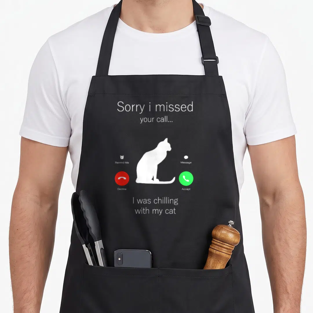 Funny kitten kitty cat apron - White cat silhouette on grey call screen with red decline and green accept buttons — shown on a black cotton canvas apron against a white background