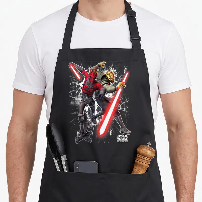 Maul savage apron - Darth Maul and Savage Opress fighting with red lightsabers and Clone Wars logo — shown on a black cotton canvas apron against a white background