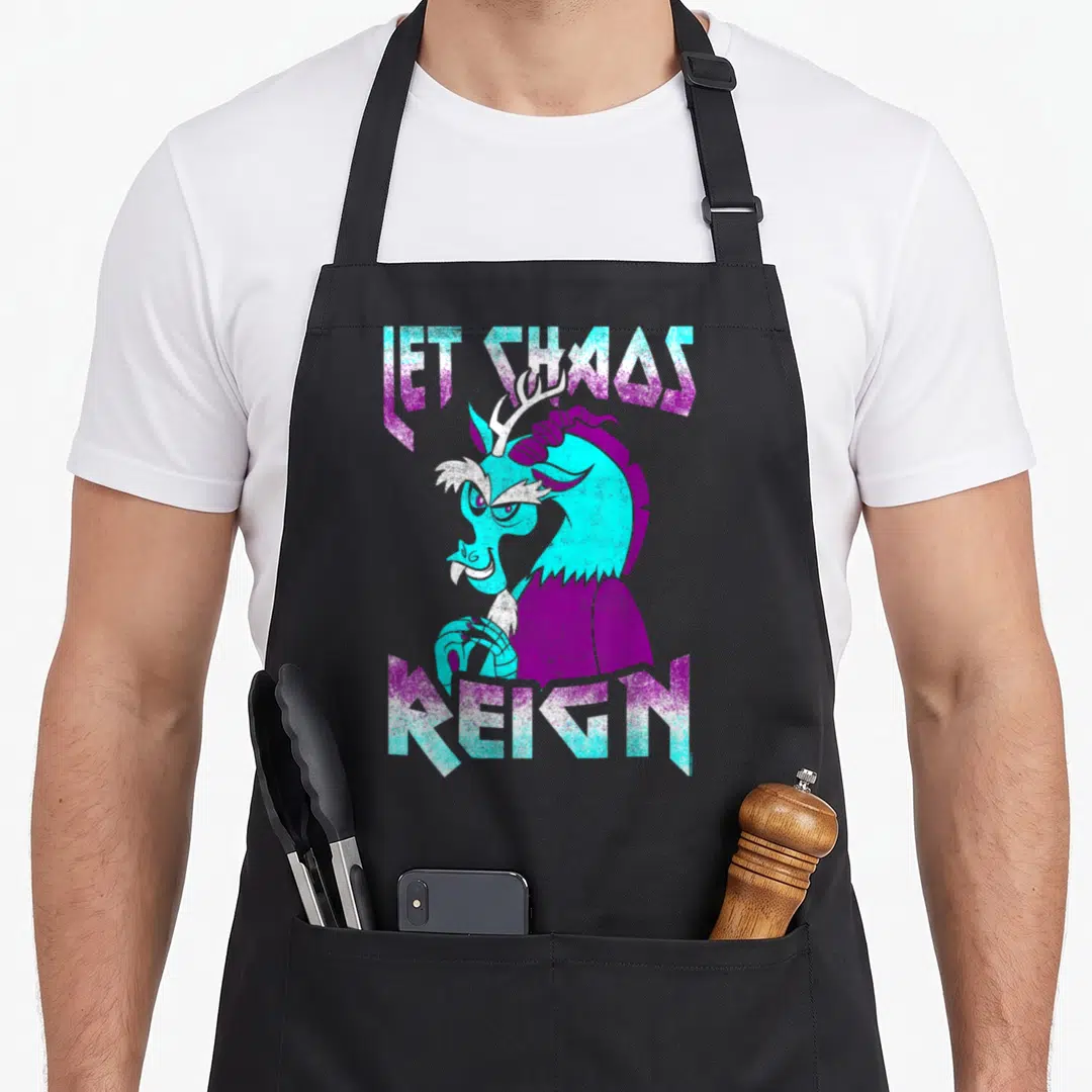 Chao magic apron - Cyan and purple dragon illustration between the text LET CHAOS REIGN — shown on a black cotton canvas apron against a white background