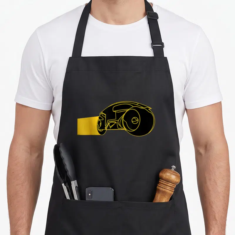 Tron game aprons - Black podracer with yellow outlines and motion blur trail on canvas — shown on a black cotton canvas apron against a white background