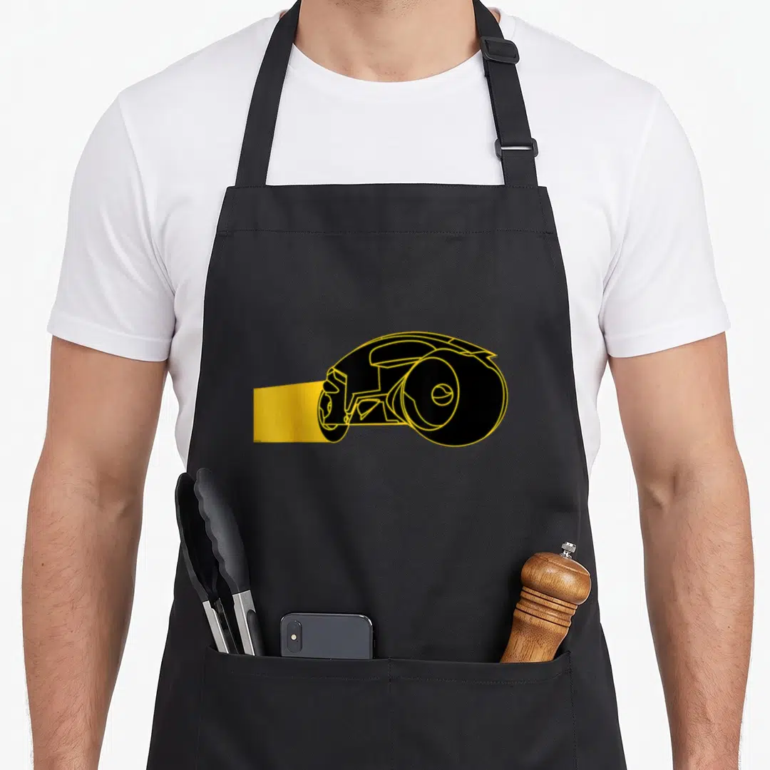Tron game aprons - Black podracer with yellow outlines and motion blur trail on canvas — shown on a black cotton canvas apron against a white background