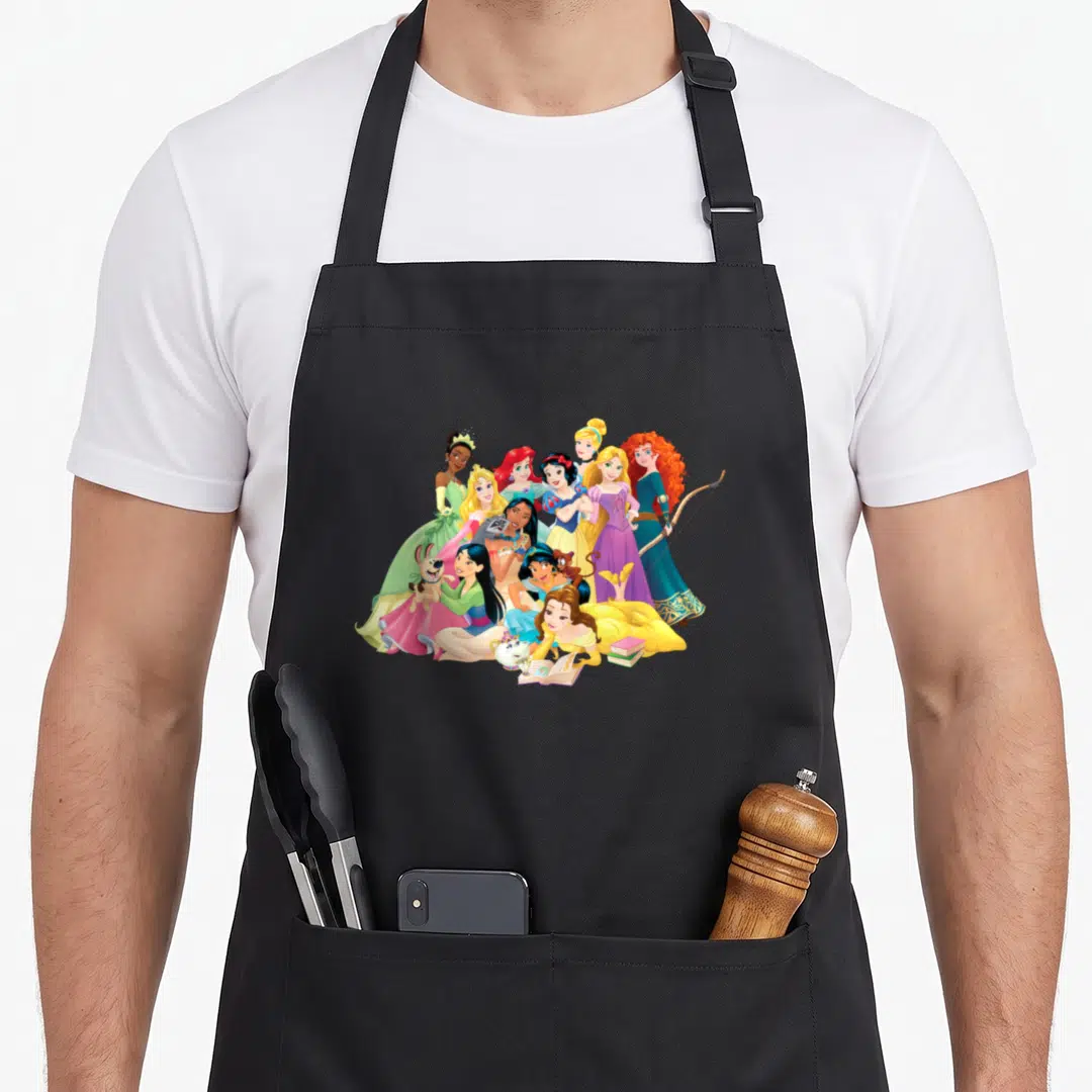 Funny princess apron - Cartoon Disney princesses in yellow blue pink green purple dresses posing with animals — shown on a black cotton canvas apron against a white background