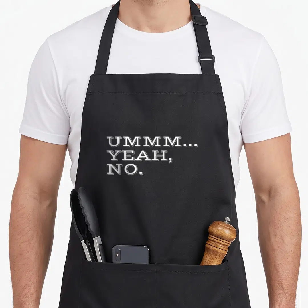 Ummm sarcastic apron - Stacked white text reading UMMM... YEAH, NO. on black fabric background — shown on a black cotton canvas apron against a white background