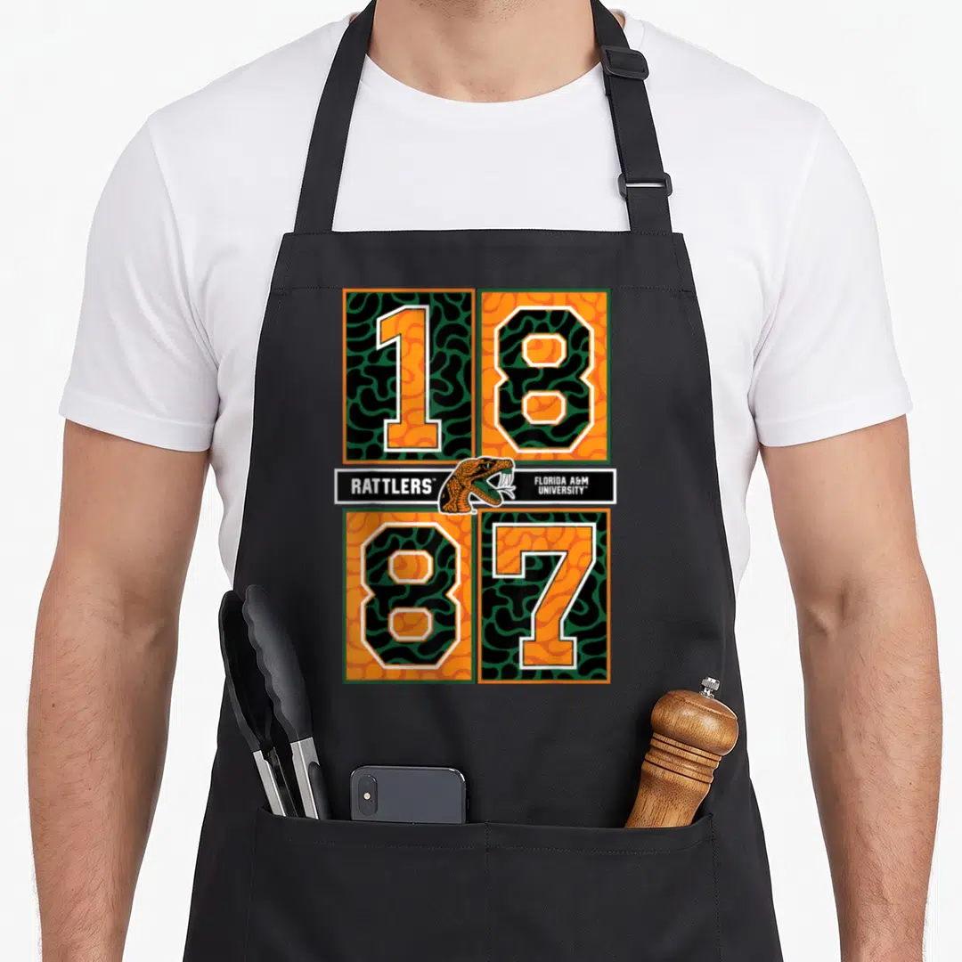 Rattler florida apron - Snake head and 1887 numbers in orange green black white blocks — shown on a black cotton canvas apron against a white background