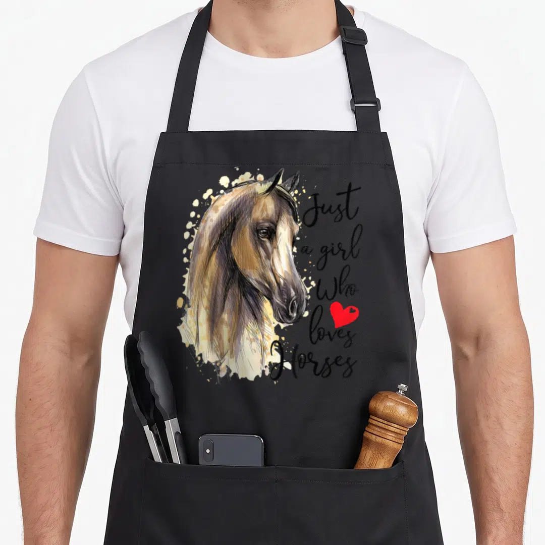 Cool riding horse apron - Realistic horse head with brown mane, black script text, and small red heart symbol — shown on a black cotton canvas apron against a white background