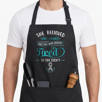 Spoonie zebra apron - Sarcasm typography and black white zebra striped ribbon for Ehlers-Danlos Syndrome awareness — shown on a black cotton canvas apron against a white background