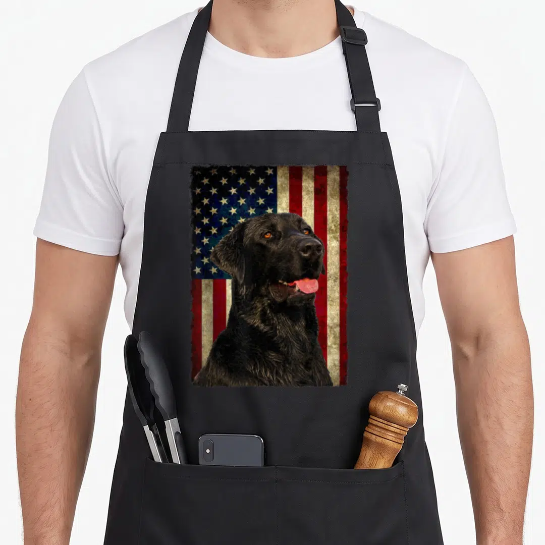 Flag labrador apron - Black labrador portrait over distressed red white and blue USA flag — shown on a black cotton canvas apron against a white background