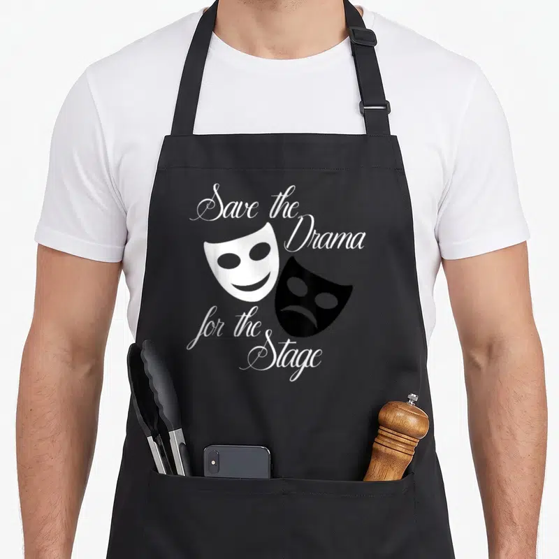 Save theater apron - Two drama masks and script text reading save the Drama for the Stage — shown on a black cotton canvas apron against a white background