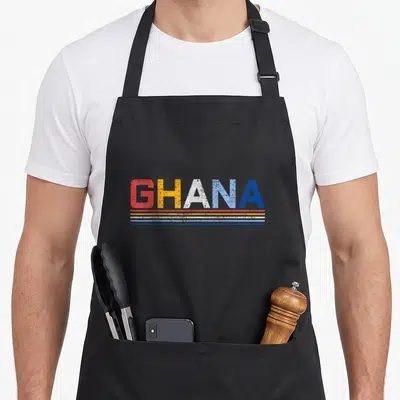 West country apron - Distressed GHANA text above red yellow white and blue horizontal stripes — shown on a black cotton canvas apron against a white background