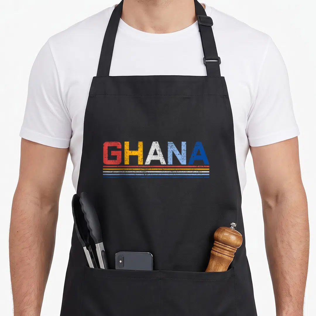 West country apron - Distressed GHANA text above red yellow white and blue horizontal stripes — shown on a black cotton canvas apron against a white background