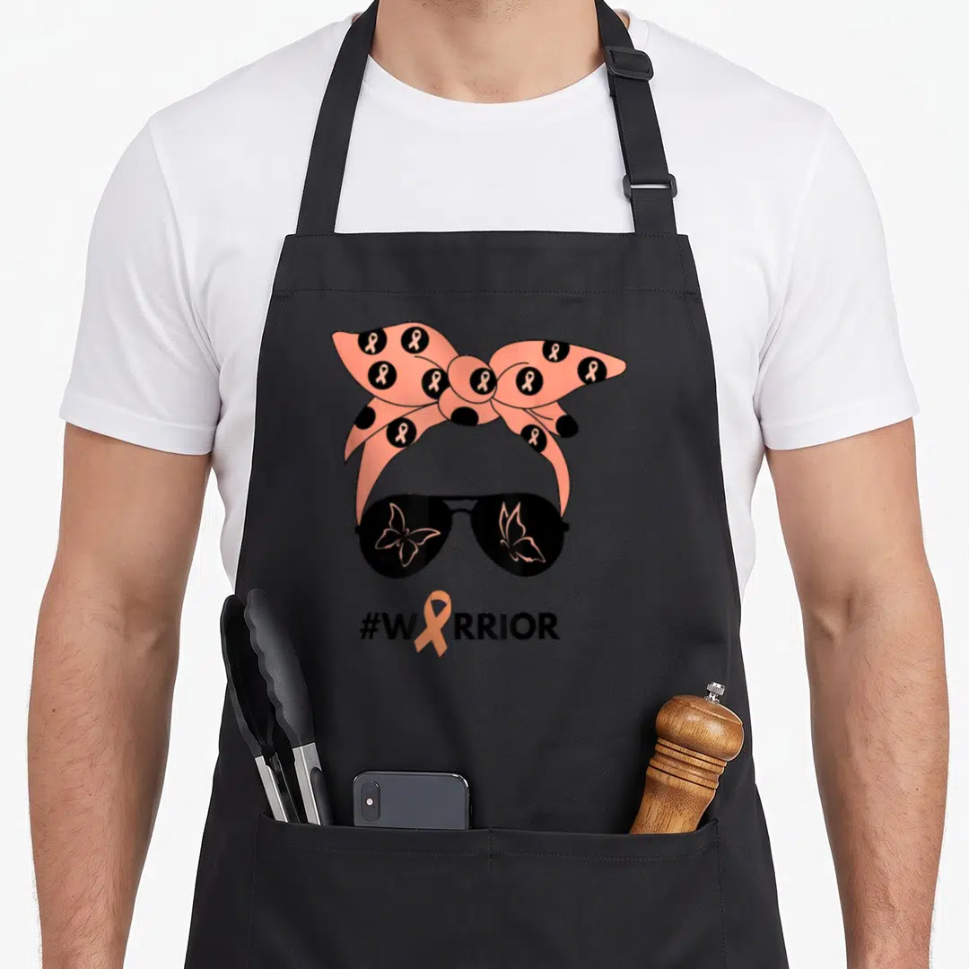 Peach bandana apron - Peach headband with awareness ribbons and black sunglasses with butterfly reflections above — shown on a black cotton canvas apron against a white background