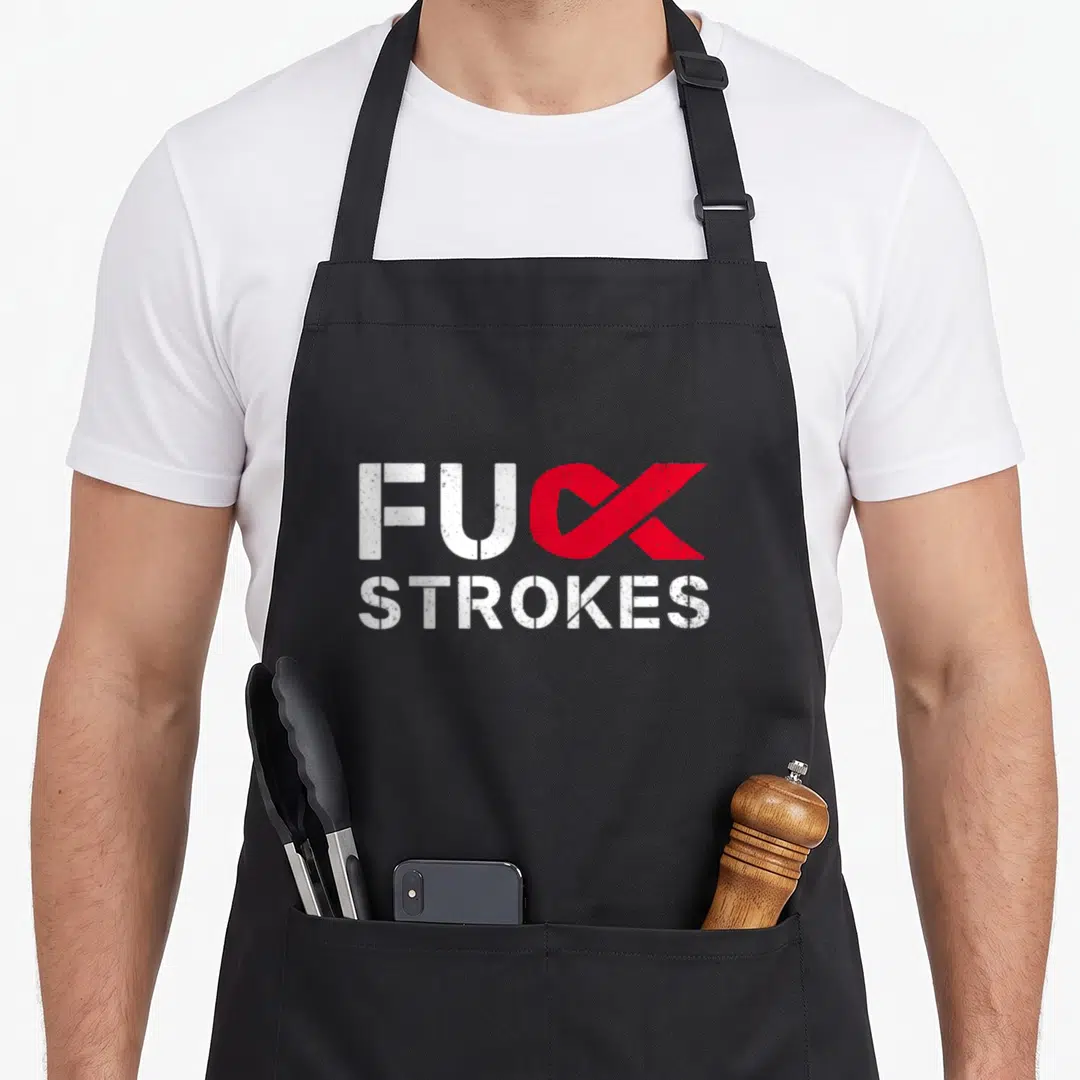 Stroke survivor awareness ribbon apron - Red ribbon K replacing FUC STROKES text in distressed white font — shown on a black cotton canvas apron against a white background